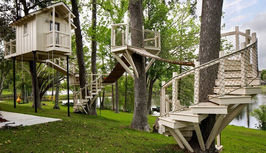 White treehouse with ladder bridge