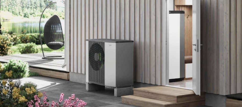 Modern heat pumps outside a home in summer